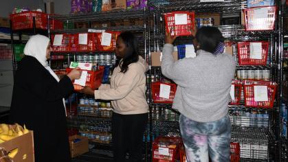 Hend El-Buri, director of PantryRUN, left, helps prepare packages of food with student workers Shatiah Bulger, center, and Karyna Anderson. PHOTO CREDIT: Yolenni Torres