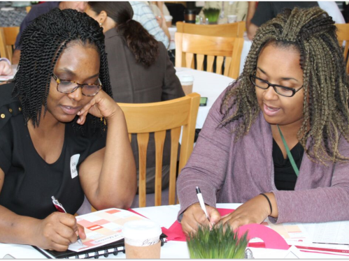 An african american woman being mentored at an OASIS event