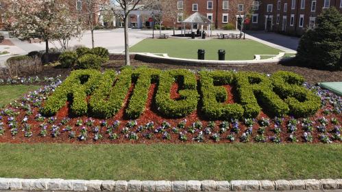 The word Rutgers spelled out in the bushes