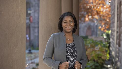 Enobong Anna Branch smiling in front of brown columns - Winants Hall