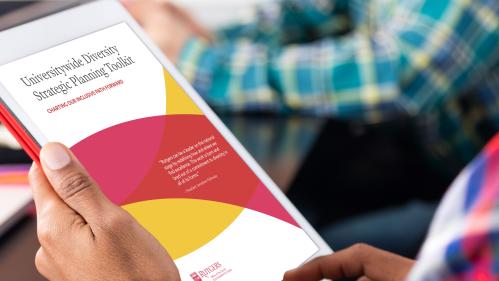 closeup of a woman's hand holding an electronic tablet reading the Diversity Planning Kit document