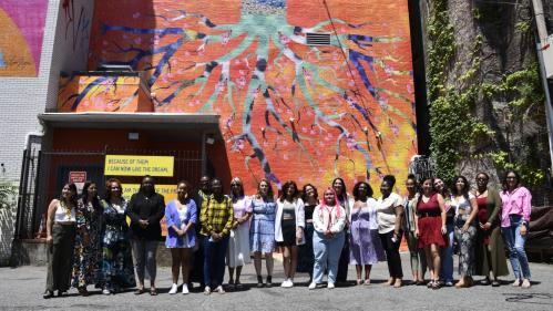 Artists pose with PES co-directors Rebecca Jampol and Jasmine Wahi (center) in front of their mural. Photo by Rachel Fawn Alban