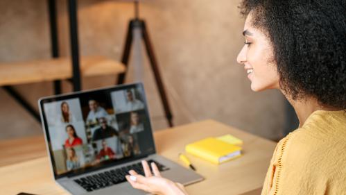 Woman speaking to colleagues in a virtual meeting