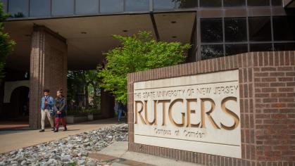A photo of the concrete sign that says "The state of New Jersey Rutgers - Campus at Camden"
