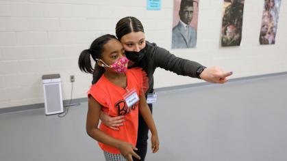 Instructor Jackie Carelli points third grader Phoenix Patilla to her spot on the floor during an after school program at Paul Robeson Community School for the Arts in New Brunswick.