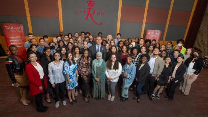 President Jonathan Holloway poses with students at the Rutgers Summer Service Internship Initiative launch event on May 19, 2022.