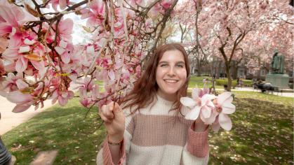 Talia Rosen posed in front of cherry blossom tree