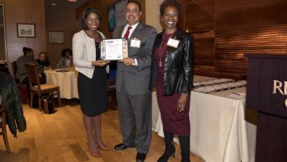 Charles Senteio (center), associate professor of library and information science, with Anna Branch (left) and Corlisse Thomas (right), a member of the Committee to Advance Our Common Purposes, received the Public Good Pinnacle Award.