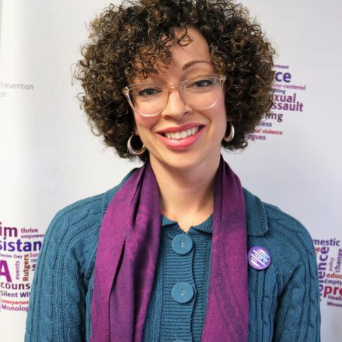 Rebecca Vazquez - A spanish woman with short curly hair. She is wearing a licite glasses, a teal sweater and a purple scarf