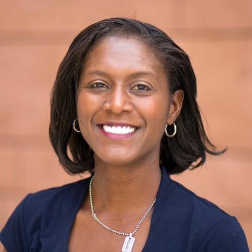 Lisa is an african american woman with a straight bob hairstyle. She is smiling and wearing a navy blue blouse.
