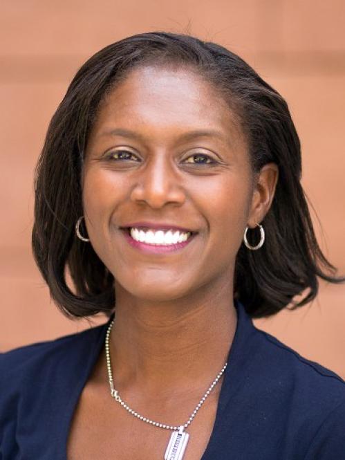 Lisa is an african american woman with a straight bob hairstyle. She is smiling and wearing a navy blue blouse.