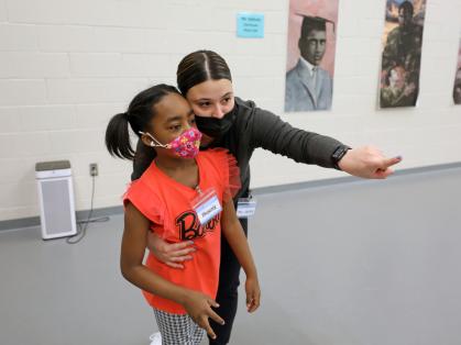 Instructor Jackie Carelli points third grader Phoenix Patilla to her spot on the floor during an after school program at Paul Robeson Community School for the Arts in New Brunswick.