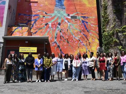 Artists pose with PES co-directors Rebecca Jampol and Jasmine Wahi (center) in front of their mural. Photo by Rachel Fawn Alban