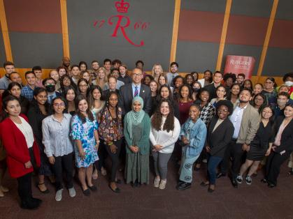 President Jonathan Holloway poses with students at the Rutgers Summer Service Internship Initiative launch event on May 19, 2022.
