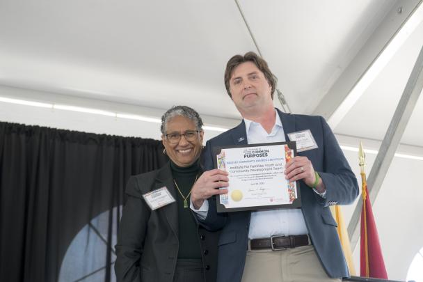 Denise Rodgers (MD), Vice Chancellor Interprofessional Programs, RBHS , CACP Chair, pictured with Beloved Community Award recipient Adam Staats, Institute For Families Youth and Community Development Team (New Brunswick)